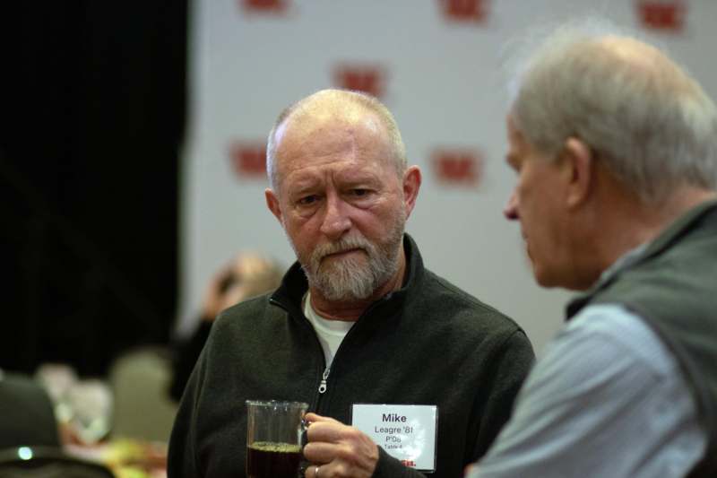 a man holding a glass of beer