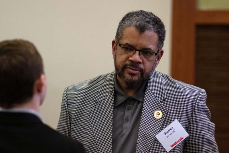 a man in a checkered jacket with a name tag