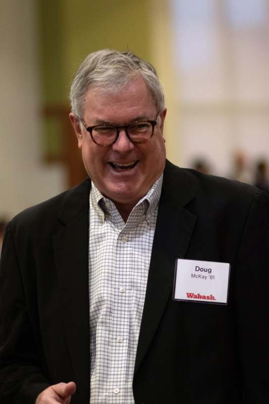 a man in a suit with a name tag