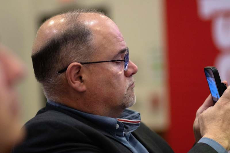 a man wearing glasses and a suit