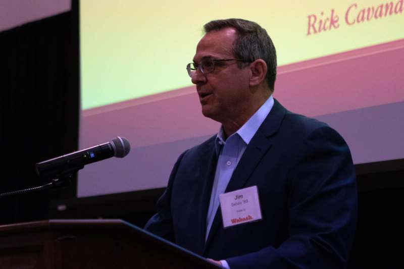 a man standing at a podium with a microphone