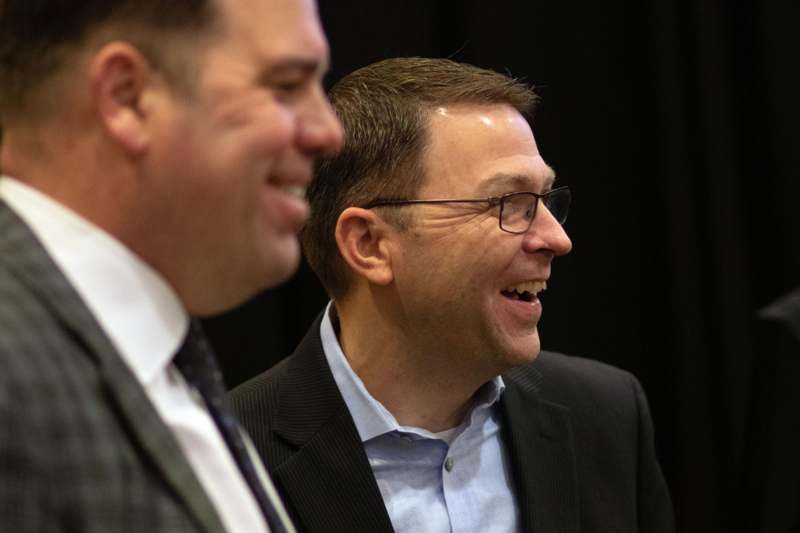 a man in a suit smiling