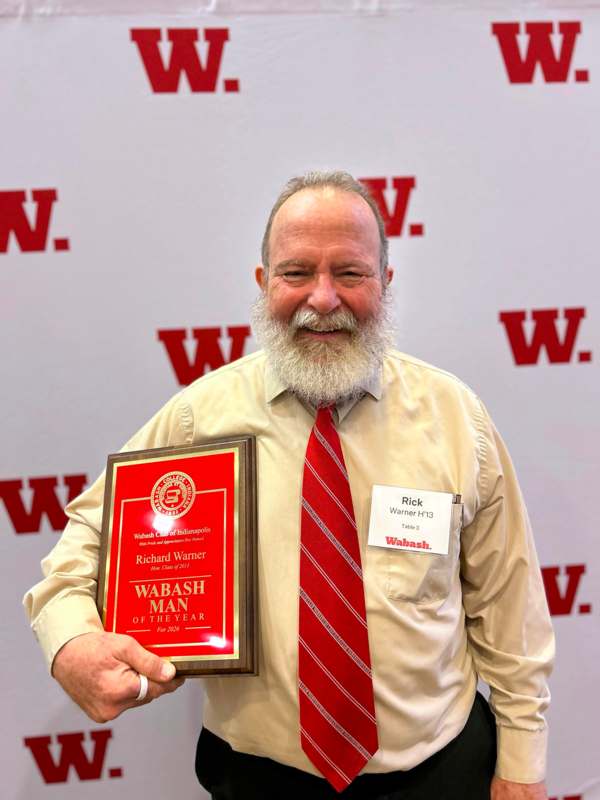 a man holding a plaque
