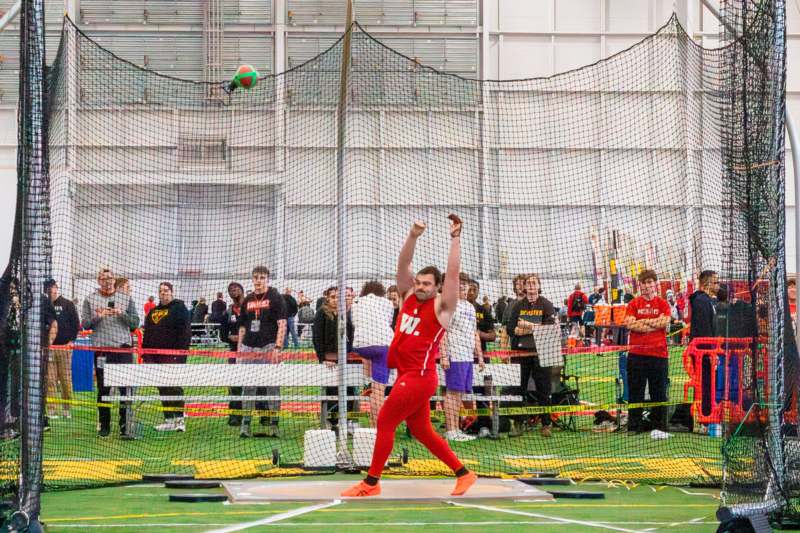 a man throwing a ball in a net