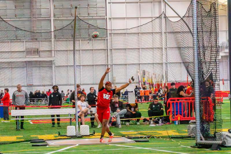 a man throwing a ball in a net