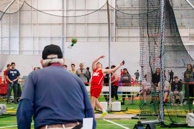 a man throwing a ball in a net