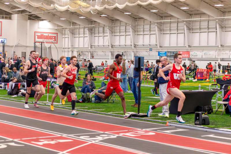 a group of people running on a track