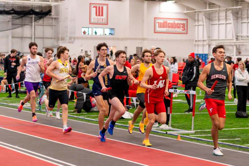 a group of people running on a track