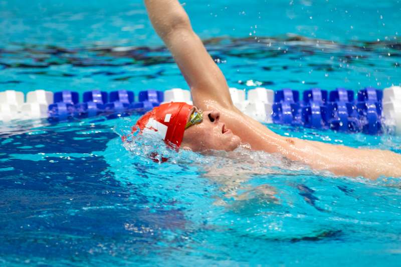 Ryan West '28 Swims at NCAA Championships - a man swimming in a pool