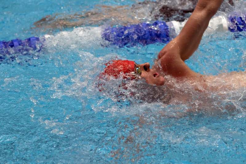 a man swimming in a pool