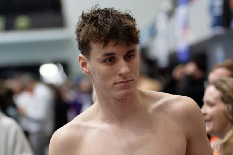 a man looking down with no shirt