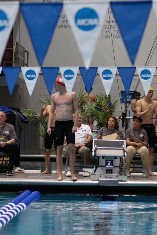 a man standing on the edge of a swimming pool