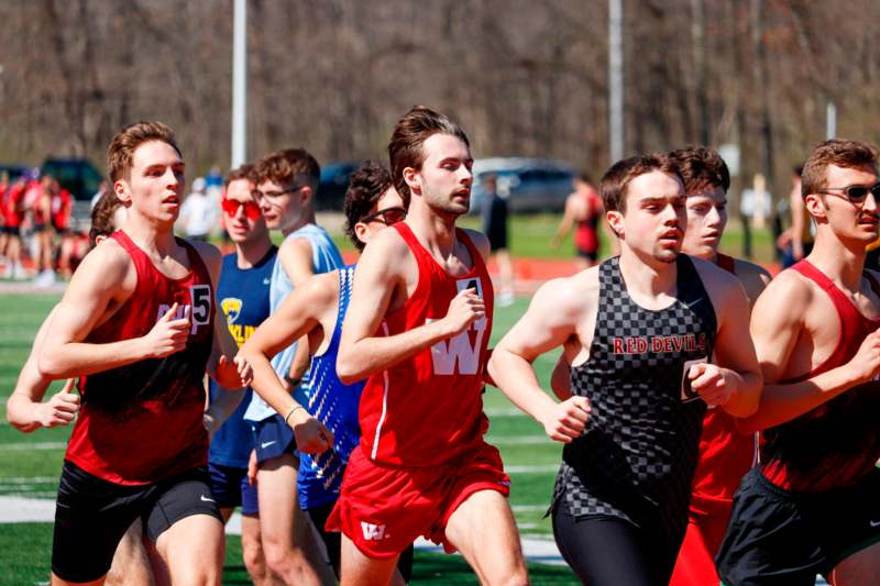 a group of men running on a track