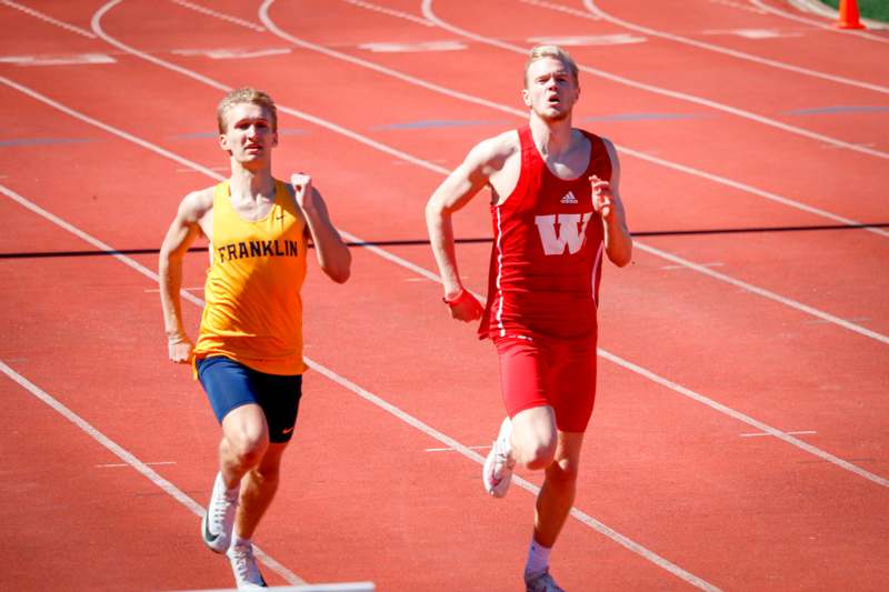 two men running on a track