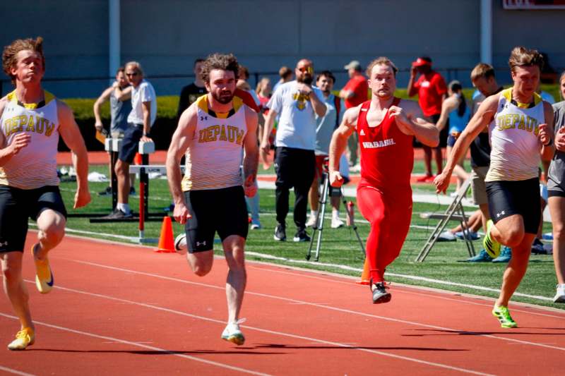 a group of men running on a track