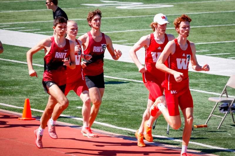 a group of men running on a track