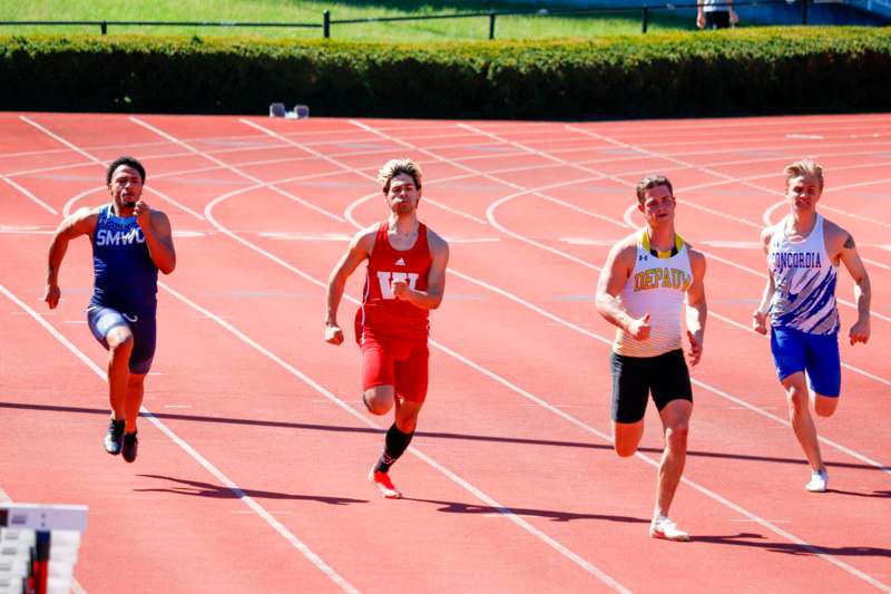 a group of men running on a track