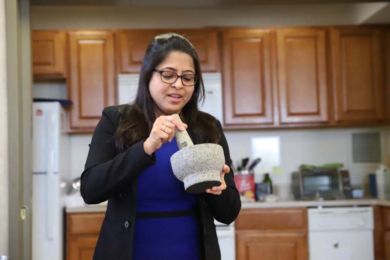 a woman holding a mortar and pestle