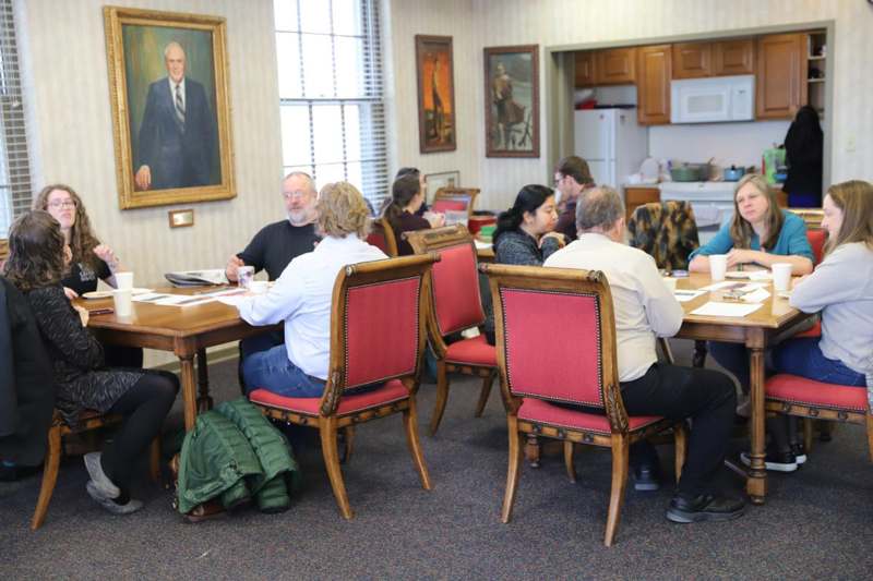 a group of people sitting around a table