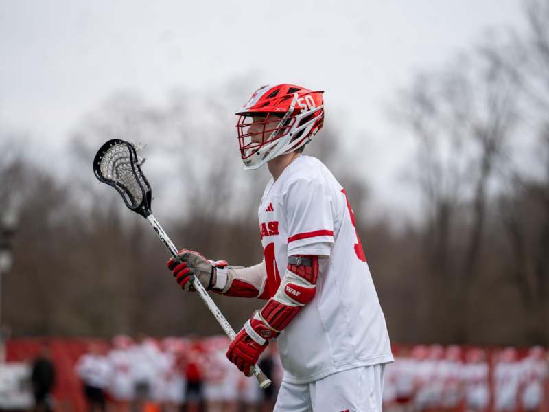 a man wearing a lacrosse uniform and holding a stick