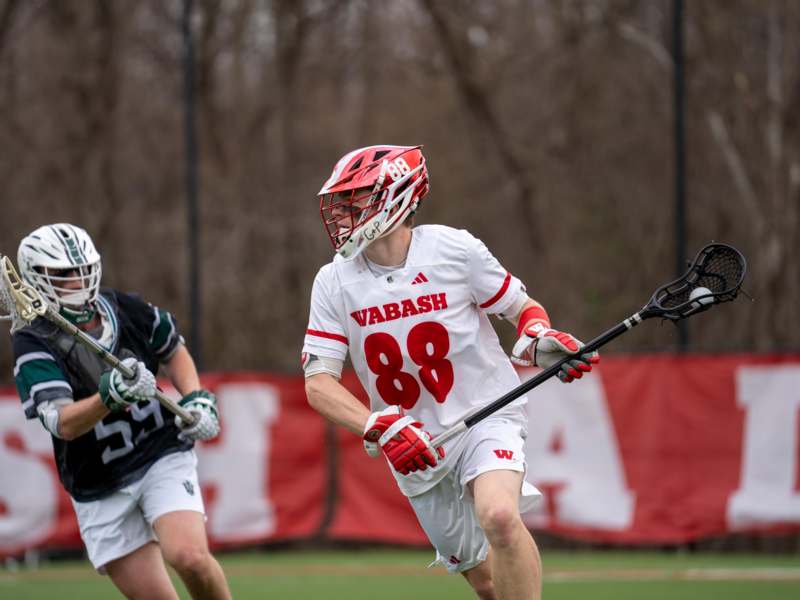 a group of people playing lacrosse