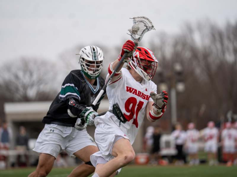 a group of people playing lacrosse