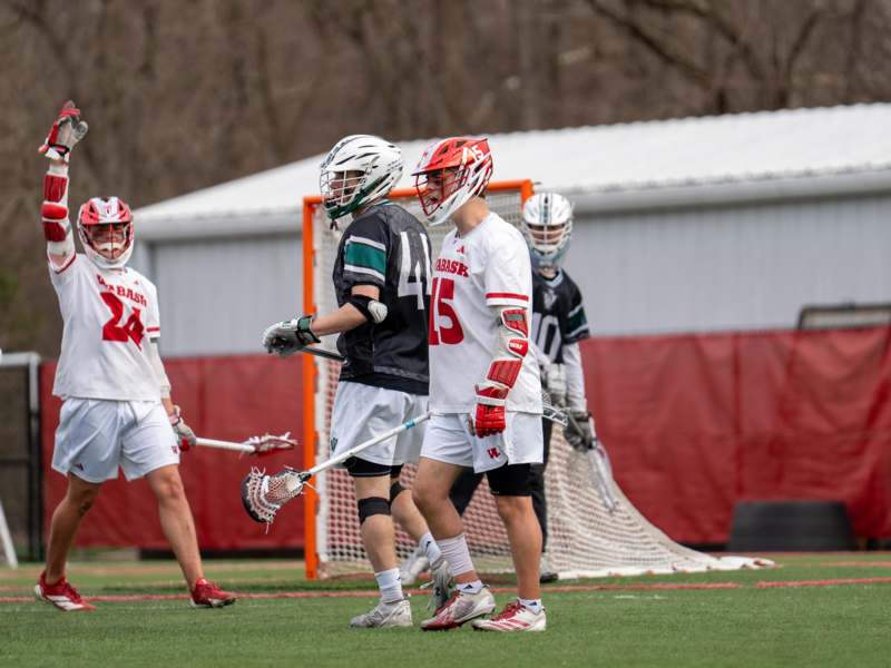 a group of people wearing helmets and holding sticks