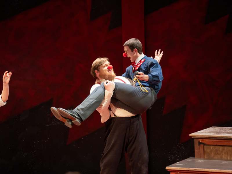 a man holding a clown on his back