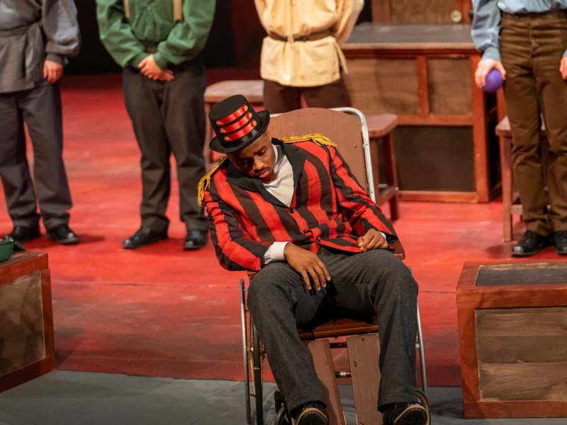 a man in a chair with a hat