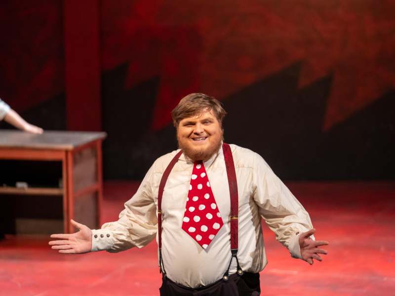 a man wearing a tie and suspenders