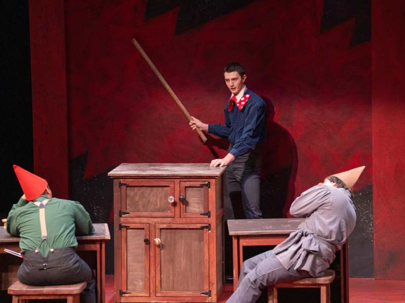 a man holding a stick on a table