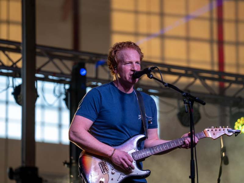 a man playing guitar on stage