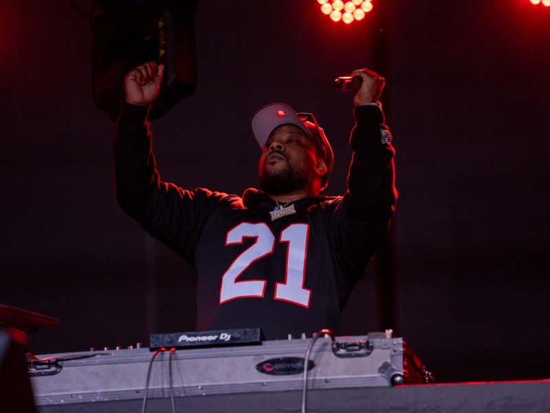 a man holding a microphone and standing on a stage