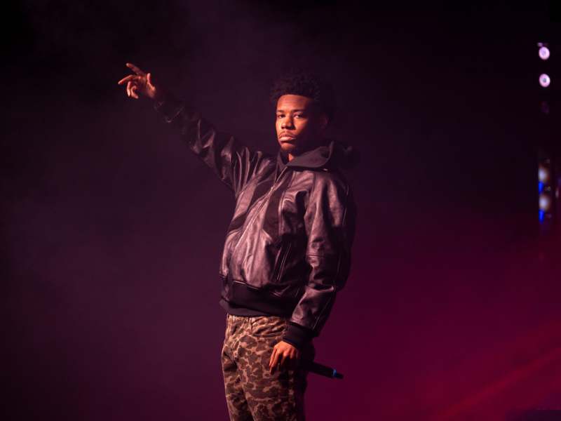 a man holding a microphone and pointing his finger