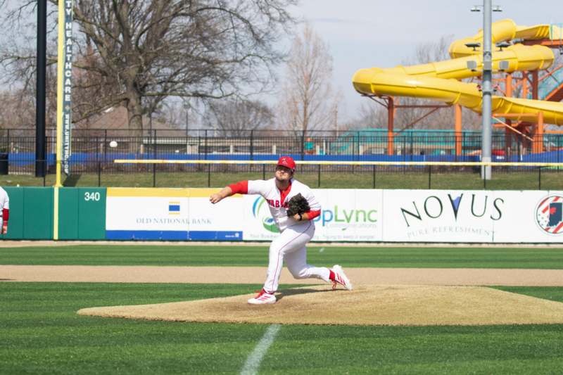 Baseball vs. Adrian College - a baseball player on a field