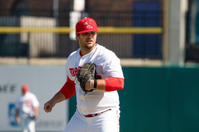 a baseball player in a red hat