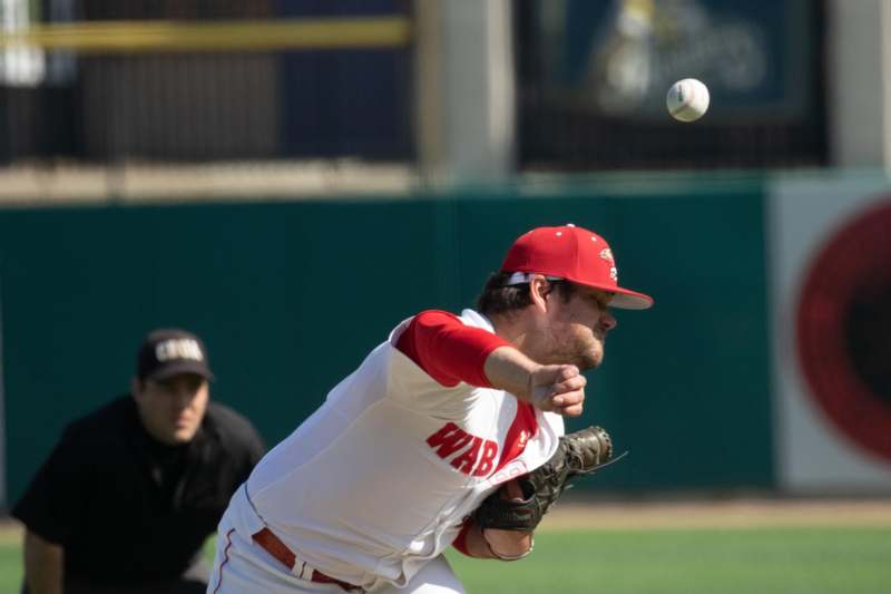 a baseball player throwing a ball