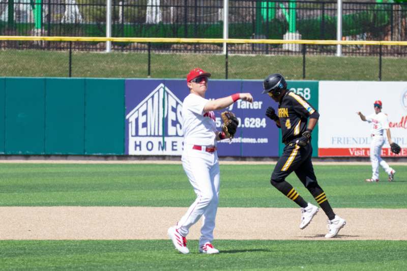 a baseball player throwing a baseball
