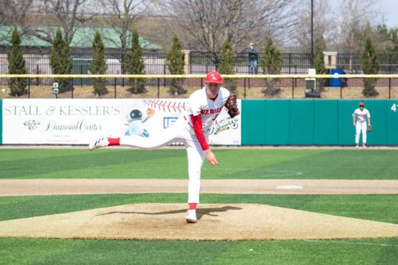 a baseball player throwing a ball