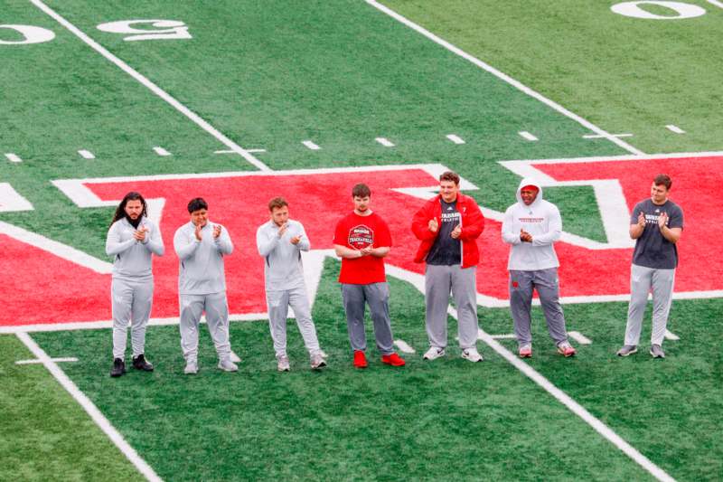 Huntsman Family Invitational - April 4,  2026 - a group of men standing on a football field