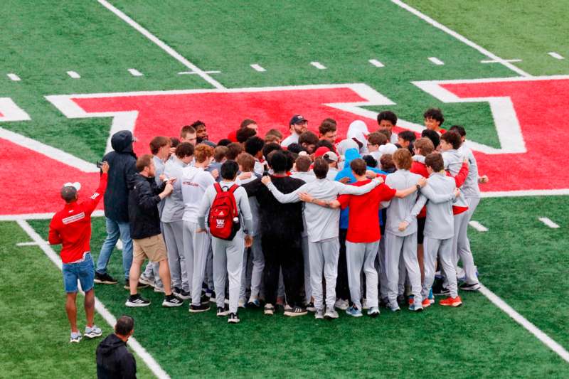 a group of people in a huddle on a football field