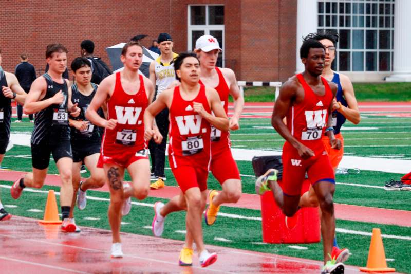 a group of people running on a track