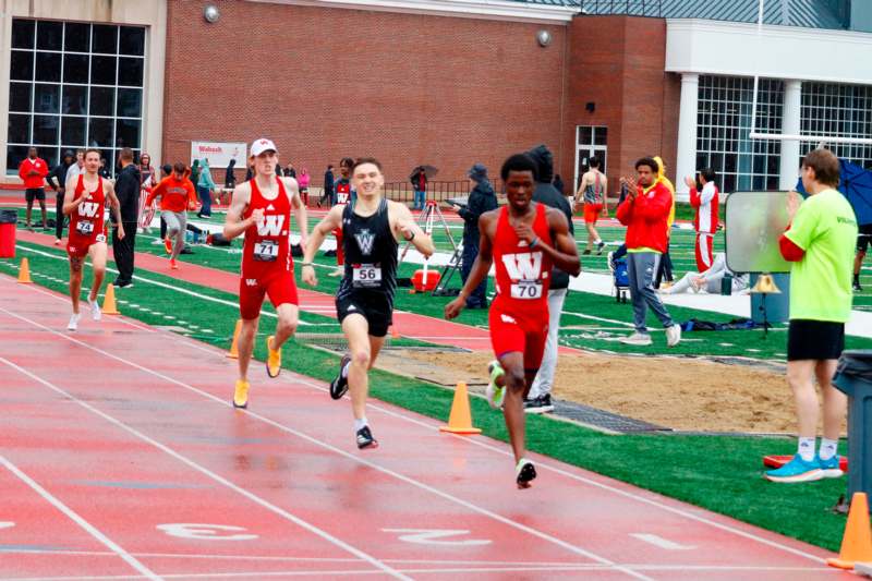 a group of men running on a track