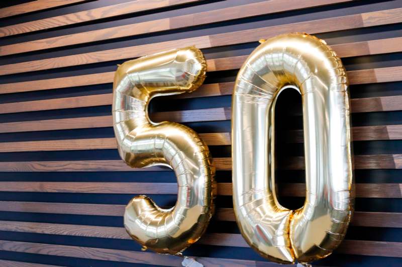 Big Milestone for Coach Morgan! - a gold balloons on a wall