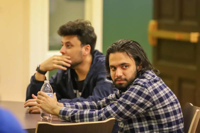a group of men sitting at a table