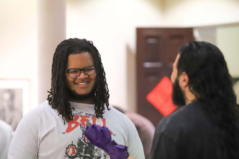 a man with long dreadlocks smiling