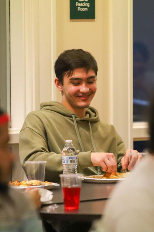 a man sitting at a table eating food