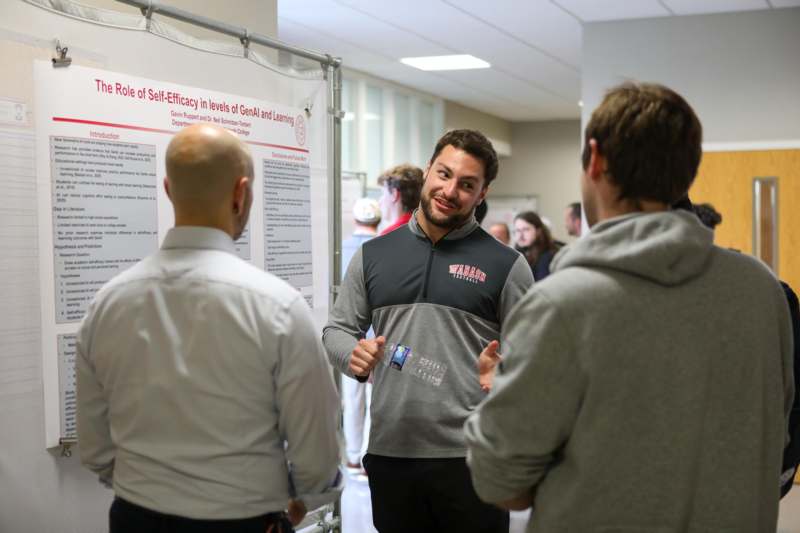 a man standing in front of a poster