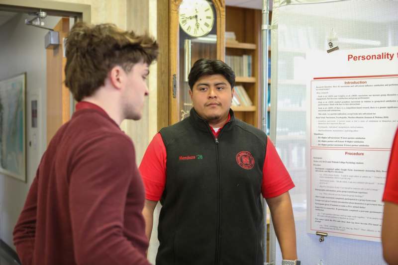 a man standing next to another man