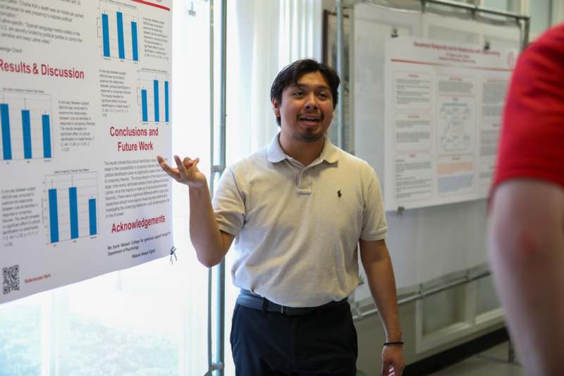 a man standing in front of a poster